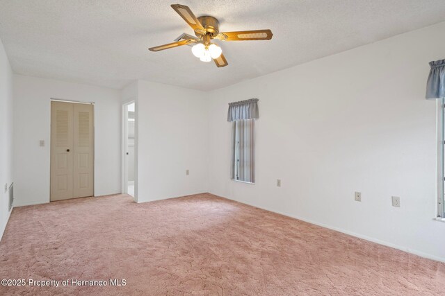10820 Hachita Dr, Port Richey, FL 34668 - unfurnished room with light colored carpet, a ceiling fan, and a textured ceiling