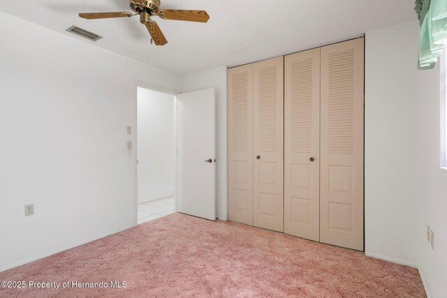 10820 Hachita Dr, Port Richey, FL 34668 - unfurnished bedroom with carpet, a closet, and ceiling fan