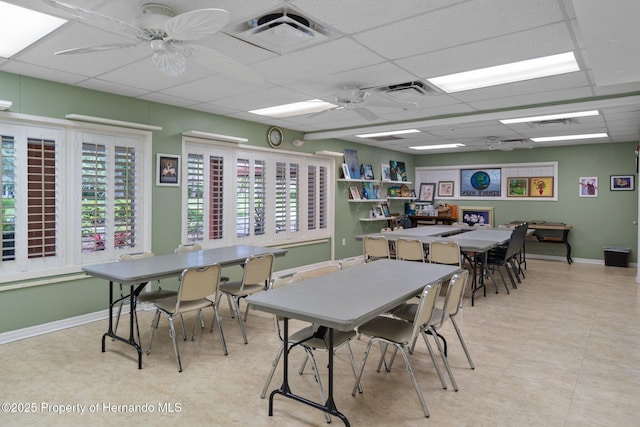 10820 Hachita Dr, Port Richey, FL 34668 - dining area featuring a paneled ceiling, baseboards, a ceiling fan, and tile patterned floors