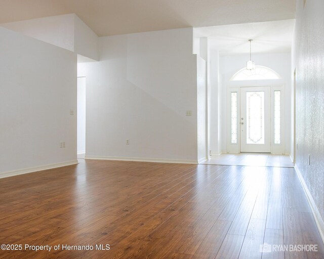 3095 Coronet Ct, Spring Hill, FL 34609 - entrance foyer featuring wood finished floors, baseboards, and a chandelier
