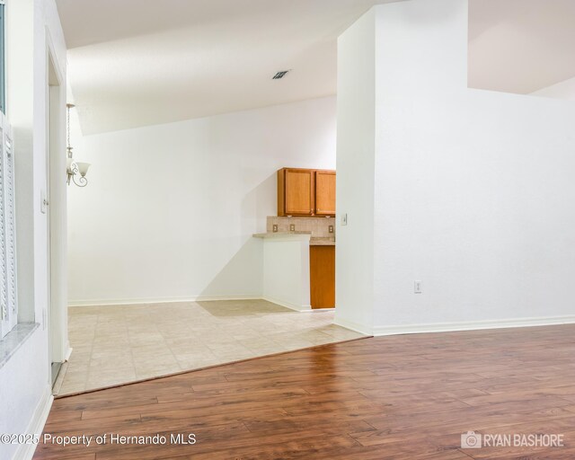 3095 Coronet Ct, Spring Hill, FL 34609 - unfurnished living room with light wood-style flooring and baseboards