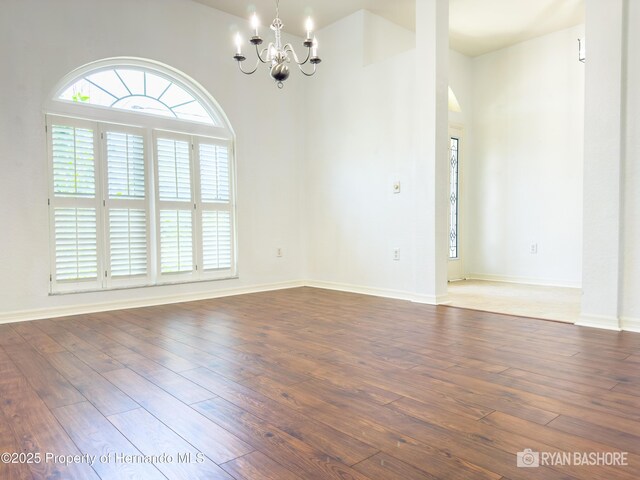 3095 Coronet Ct, Spring Hill, FL 34609 - spare room featuring a chandelier, plenty of natural light, hardwood / wood-style flooring, and baseboards