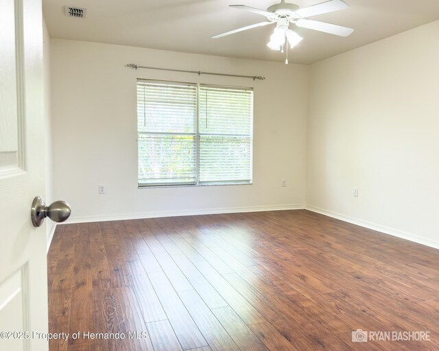 3095 Coronet Ct, Spring Hill, FL 34609 - empty room with a ceiling fan, dark wood finished floors, and baseboards