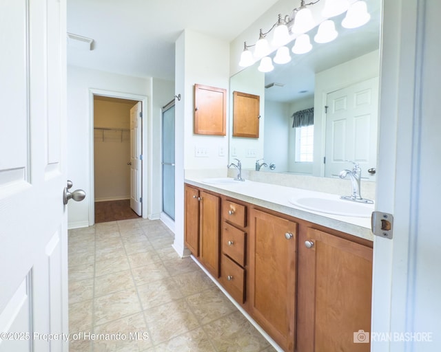 3095 Coronet Ct, Spring Hill, FL 34609 - bathroom featuring double vanity, a stall shower, and a spacious closet