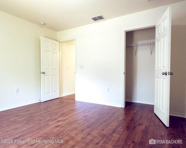3095 Coronet Ct, Spring Hill, FL 34609 - unfurnished bedroom featuring wood finished floors, a closet, and baseboards
