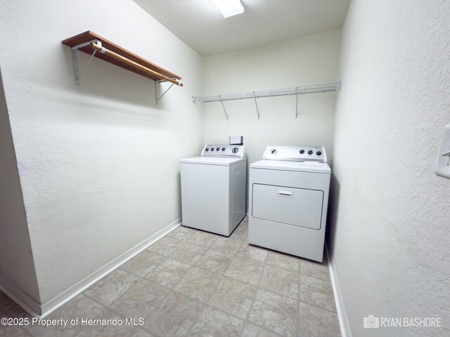3095 Coronet Ct, Spring Hill, FL 34609 - laundry room featuring washer and dryer, baseboards, and stone finish floors