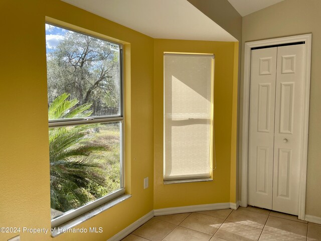 10448 Canary Ave, Weeki Wachee, FL 34613 - interior space with healthy amount of natural light, baseboards, and light tile patterned floors