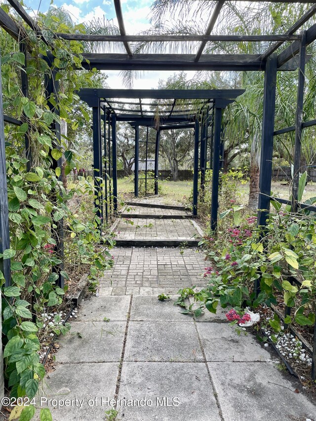 10448 Canary Ave, Weeki Wachee, FL 34613 - view of patio / terrace featuring a pergola and a gate