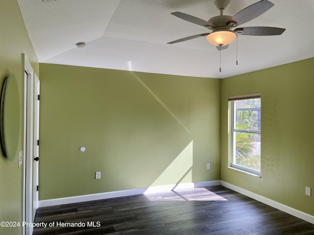 10448 Canary Ave, Weeki Wachee, FL 34613 - unfurnished room with dark wood finished floors, baseboards, a ceiling fan, a smoke detector, and vaulted ceiling