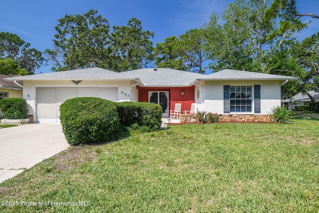 2183 Westchester Blvd, Spring Hill, FL 34606 - ranch-style home featuring an attached garage, a front lawn, driveway, and stucco siding