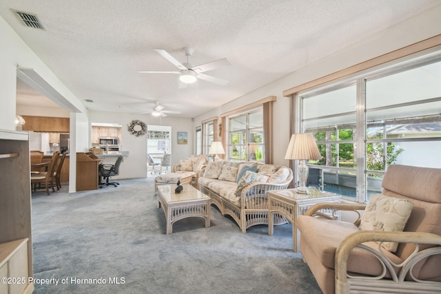 2183 Westchester Blvd, Spring Hill, FL 34606 - carpeted living area featuring a textured ceiling and ceiling fan