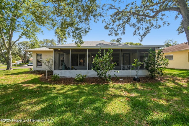 2183 Westchester Blvd, Spring Hill, FL 34606 - back of house featuring a sunroom and a lawn