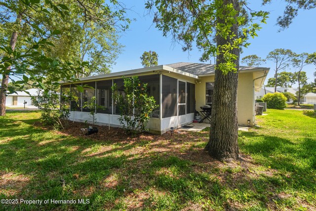2183 Westchester Blvd, Spring Hill, FL 34606 - back of property featuring a sunroom and a lawn