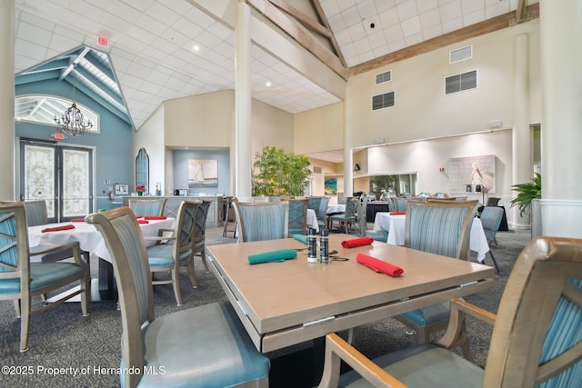 2183 Westchester Blvd, Spring Hill, FL 34606 - carpeted dining space featuring high vaulted ceiling and a chandelier