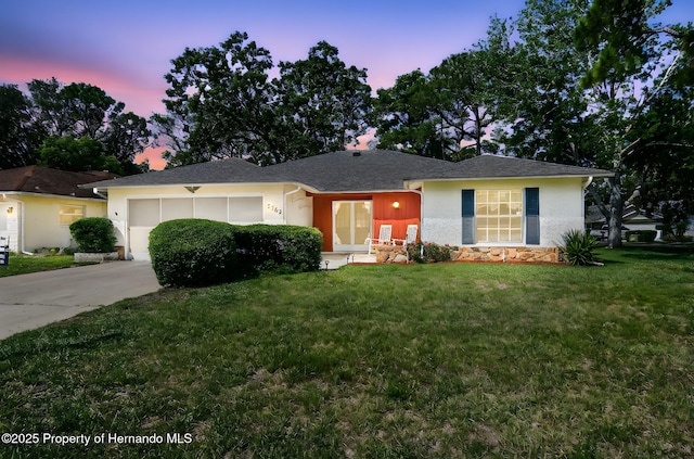 2183 Westchester Blvd, Spring Hill, FL 34606 - single story home with driveway, a garage, a front yard, stucco siding, and stone siding
