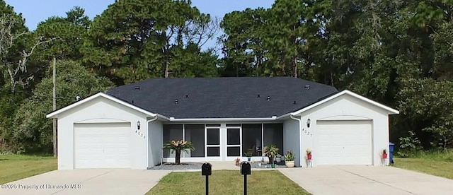 4035 Jason Rd, Spring Hill, FL 34608 - ranch-style home with driveway, a garage, stucco siding, and a front lawn