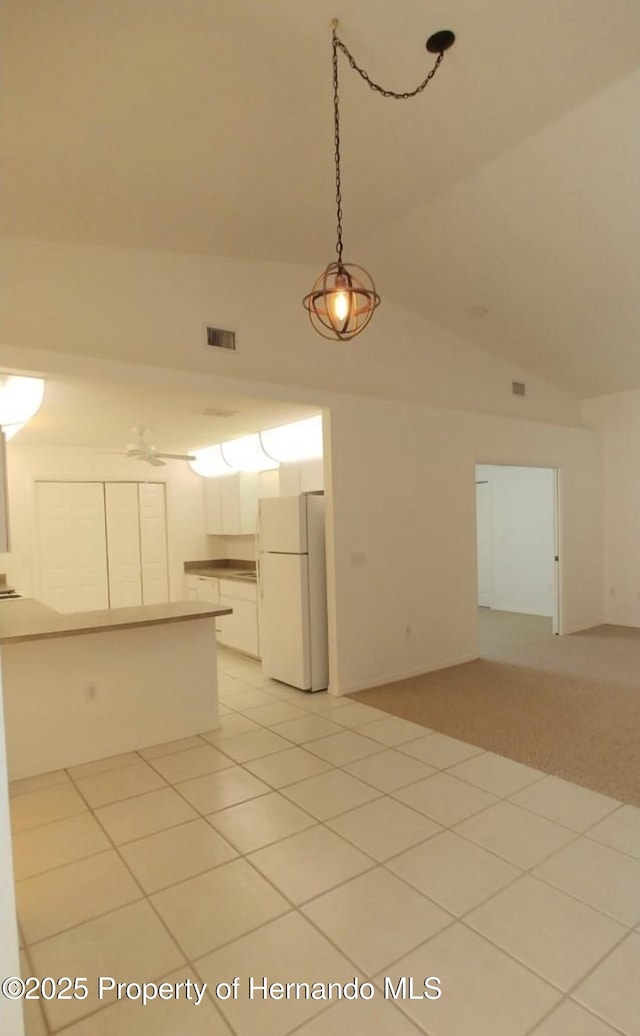 4035 Jason Rd, Spring Hill, FL 34608 - kitchen with freestanding refrigerator, white cabinetry, open floor plan, pendant lighting, and a peninsula