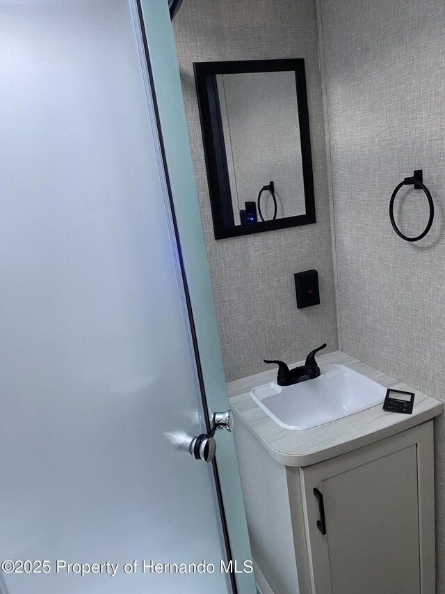 4035 Jason Rd, Spring Hill, FL 34608 - bathroom featuring tile walls and vanity