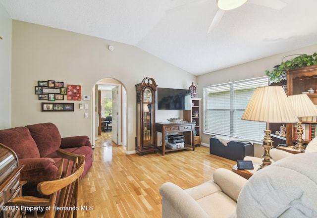 11752 Wheatfield Loop, Hudson, FL 34667 - living area with arched walkways, vaulted ceiling, ceiling fan, wood finished floors, and baseboards