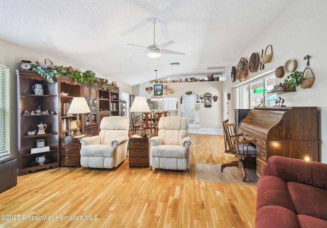 11752 Wheatfield Loop, Hudson, FL 34667 - living area featuring light wood-style floors, ceiling fan, and lofted ceiling