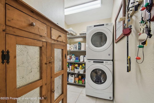 11752 Wheatfield Loop, Hudson, FL 34667 - laundry area featuring stacked washing machine and dryer and light tile patterned flooring