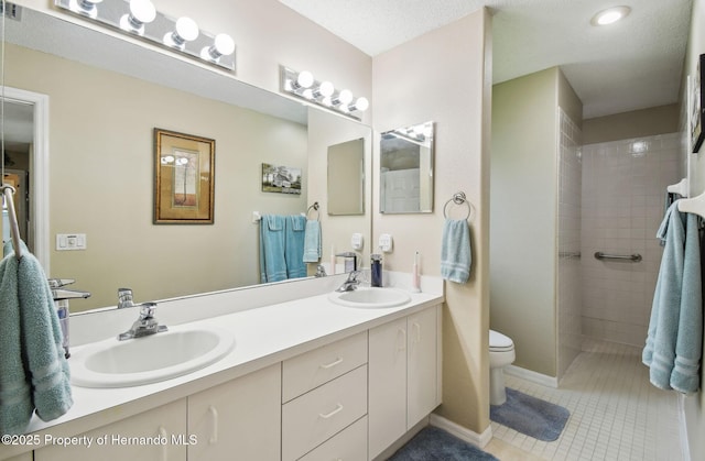11752 Wheatfield Loop, Hudson, FL 34667 - bathroom with toilet, tile patterned flooring, tiled shower, and double vanity