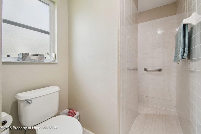 11752 Wheatfield Loop, Hudson, FL 34667 - bathroom featuring toilet and a tile shower