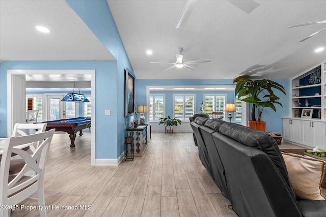 4387 6th Isle Dr, Hernando Beach, FL 34607 - living area with ceiling fan, pool table, baseboards, light wood-type flooring, and a textured ceiling