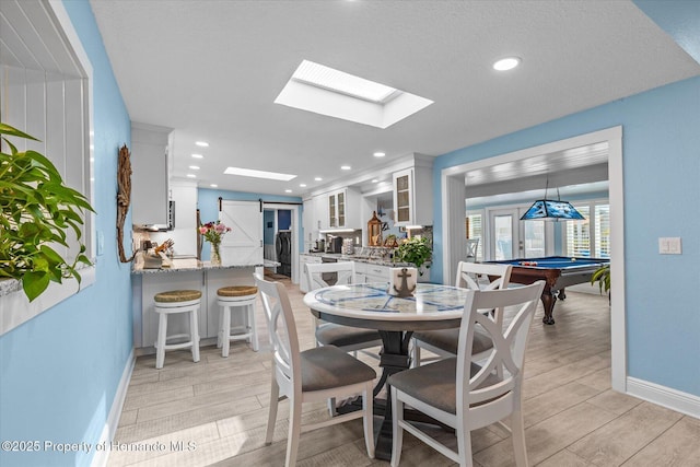 4387 6th Isle Dr, Hernando Beach, FL 34607 - dining space featuring baseboards, a skylight, light wood-style floors, billiards table, and recessed lighting