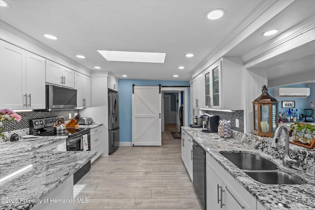 4387 6th Isle Dr, Hernando Beach, FL 34607 - kitchen featuring black appliances, a wall mounted air conditioner, a sink, white cabinetry, and recessed lighting