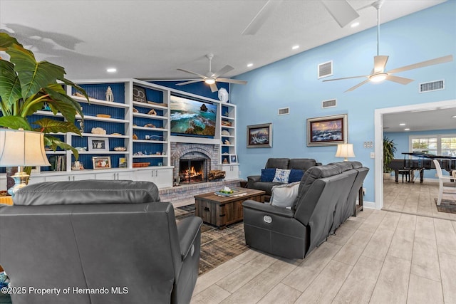 4387 6th Isle Dr, Hernando Beach, FL 34607 - living area with a ceiling fan, light wood-style flooring, vaulted ceiling, a fireplace, and built in features