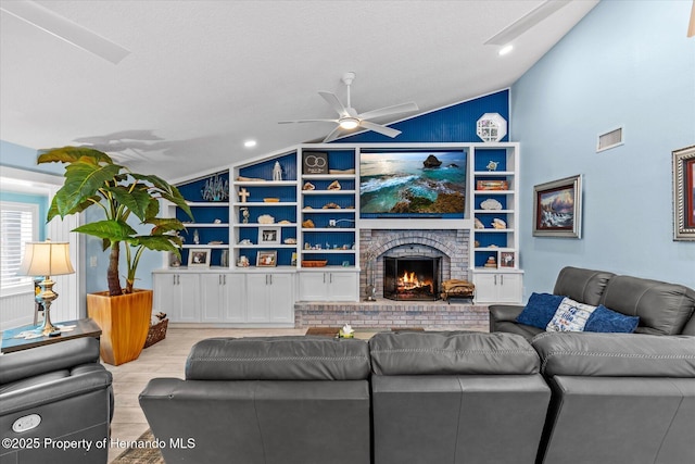 4387 6th Isle Dr, Hernando Beach, FL 34607 - living area featuring vaulted ceiling, ceiling fan, wood finished floors, and a brick fireplace