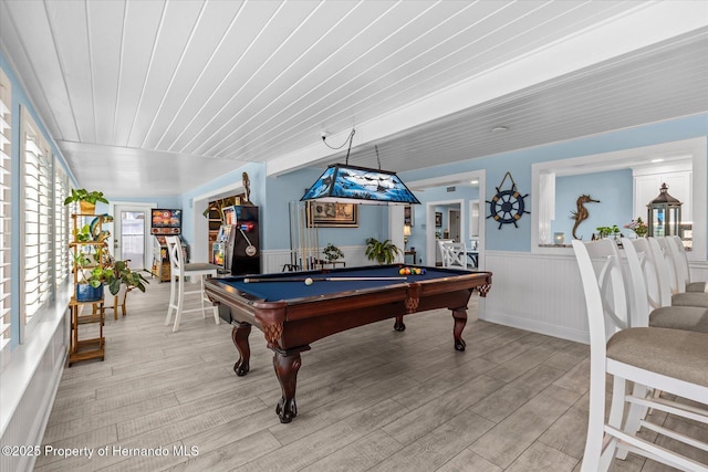 4387 6th Isle Dr, Hernando Beach, FL 34607 - game room with billiards table, a wainscoted wall, and light wood-type flooring