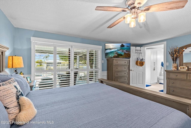 4387 6th Isle Dr, Hernando Beach, FL 34607 - bedroom with a textured ceiling, connected bathroom, and ceiling fan