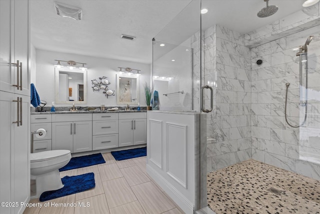 4387 6th Isle Dr, Hernando Beach, FL 34607 - bathroom featuring a shower stall, toilet, double vanity, and recessed lighting