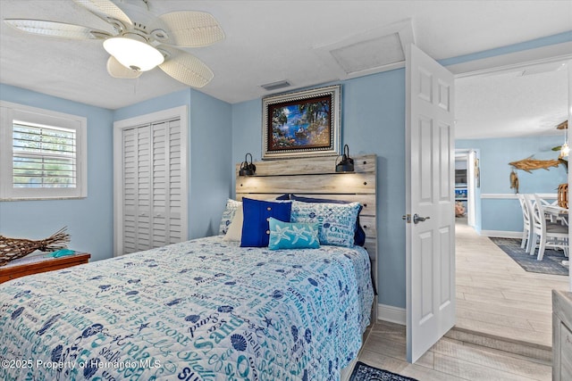 4387 6th Isle Dr, Hernando Beach, FL 34607 - bedroom with wood finished floors, attic access, baseboards, ceiling fan, and a closet