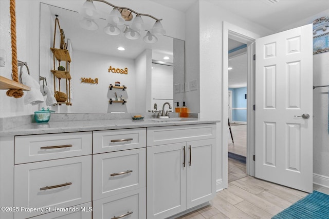4387 6th Isle Dr, Hernando Beach, FL 34607 - full bath featuring wood finished floors, vanity, recessed lighting, and baseboards