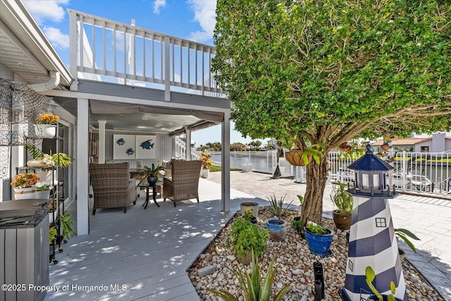 4387 6th Isle Dr, Hernando Beach, FL 34607 - fenced backyard featuring an outdoor hangout area, a deck with water view, a patio area, and a balcony