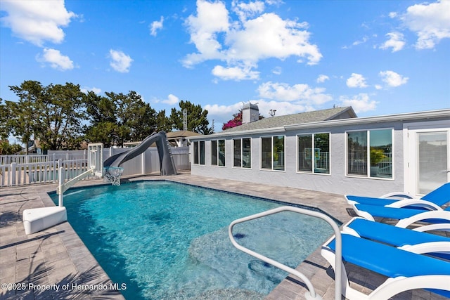 4387 6th Isle Dr, Hernando Beach, FL 34607 - view of swimming pool with a fenced backyard, a patio area, and a water slide