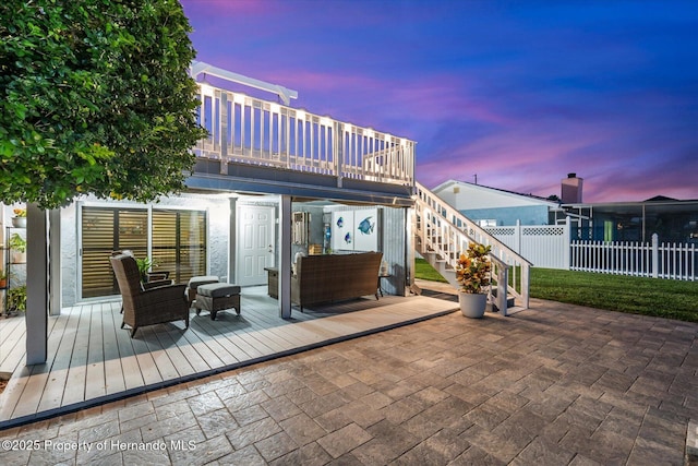 4387 6th Isle Dr, Hernando Beach, FL 34607 - patio terrace at dusk featuring a wooden deck, a patio area, and stairs