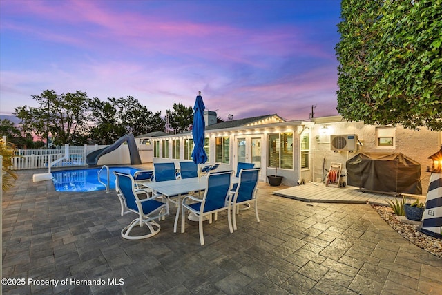 4387 6th Isle Dr, Hernando Beach, FL 34607 - view of swimming pool with a water slide, a fenced backyard, grilling area, a wooden deck, and a patio area
