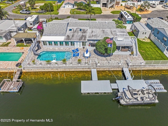 4387 6th Isle Dr, Hernando Beach, FL 34607 - aerial view of residential area featuring a pool area and a large body of water