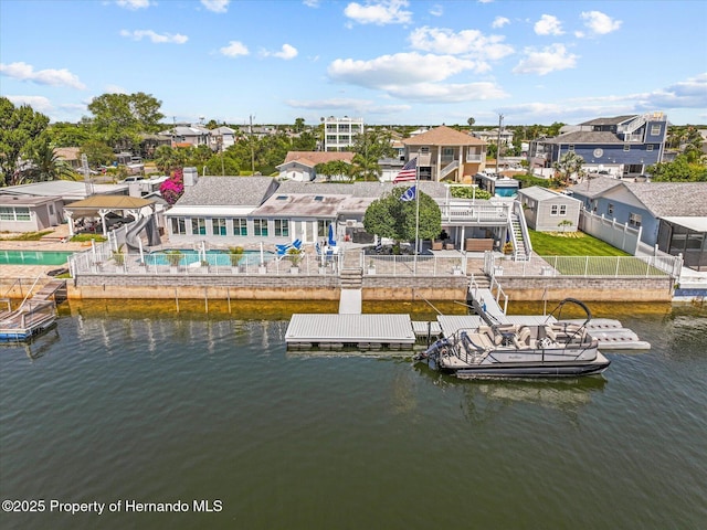 4387 6th Isle Dr, Hernando Beach, FL 34607 - dock featuring a fenced backyard, a water view, and an outdoor pool
