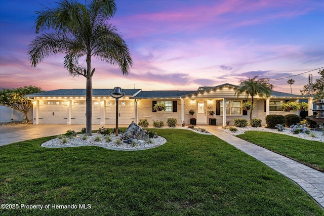 4387 6th Isle Dr, Hernando Beach, FL 34607 - ranch-style home featuring a lawn, an attached garage, and concrete driveway