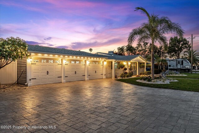 4387 6th Isle Dr, Hernando Beach, FL 34607 - ranch-style house featuring decorative driveway and an attached garage