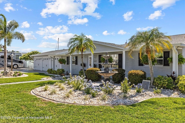 4387 6th Isle Dr, Hernando Beach, FL 34607 - ranch-style house with a front yard, an attached garage, and driveway