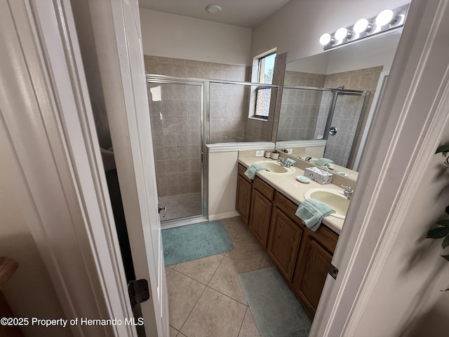 9238 Southern Charm Cir, Brooksville, FL 34613 - bathroom featuring a shower stall, tile patterned floors, and double vanity