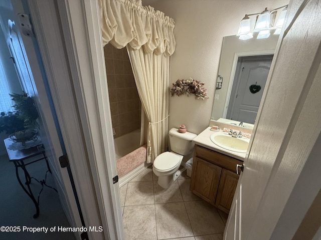 9238 Southern Charm Cir, Brooksville, FL 34613 - full bath featuring vanity, toilet, tile patterned floors, and shower / tub combo with curtain