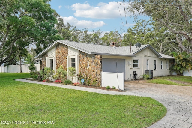 18633 Oak Way Dr, Hudson, FL 34667 - view of front of house with central AC unit, stone siding, driveway, and roof with shingles