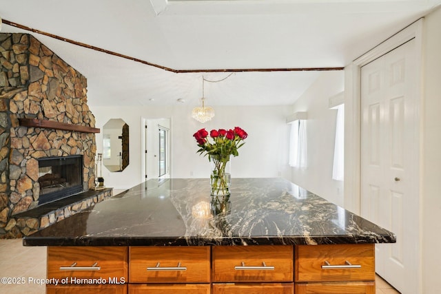 18633 Oak Way Dr, Hudson, FL 34667 - kitchen featuring light tile patterned floors, dark stone countertops, and brown cabinetry